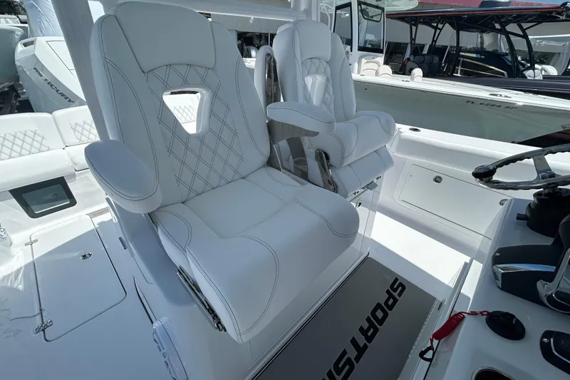 Slide: The Image of Luxurious seating on 2026 Sportsman Heritage 321 Center Console boat, featuring elegant white upholstery. - 10