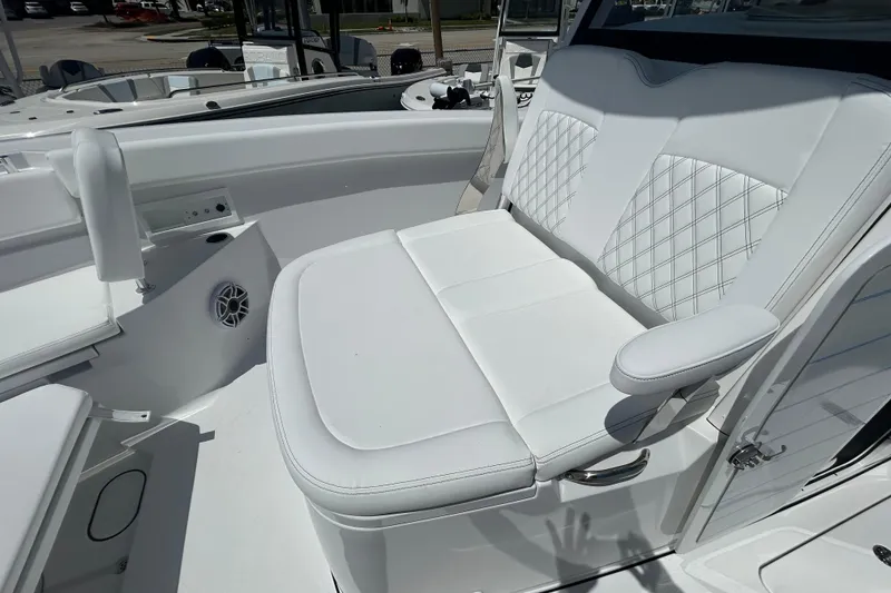 Slide: The Image of 2026 Sportsman Heritage 321 Center Console boat with luxurious white seating. - 11