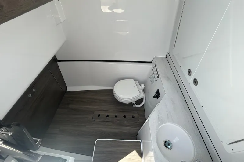 Slide: The Image of 2026 Sportsman Heritage 321 Center Console boat interior with modern bathroom amenities. - 15