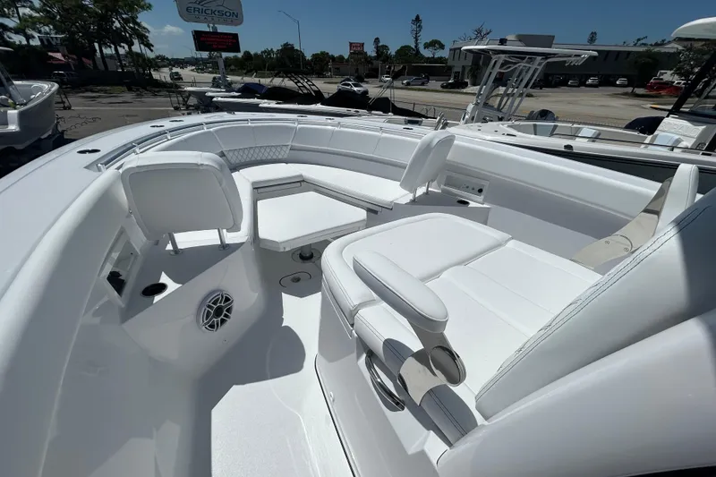 Slide: The Image of 2026 Sportsman Heritage 321 Center Console boat interior with white seating and modern design. - 16
