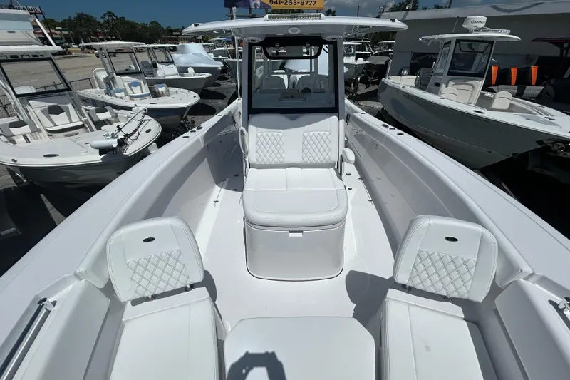 Slide: The Image of 2026 Sportsman Heritage 321 Center Console boat with white seating and sleek design. - 17