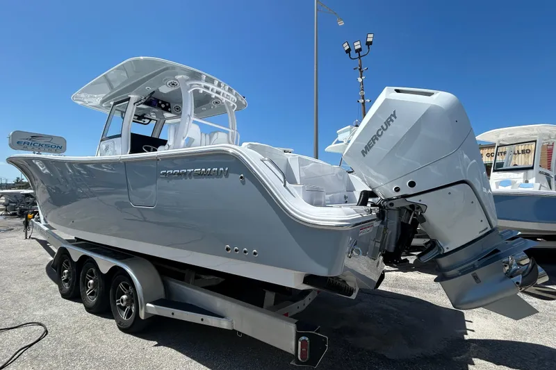 Slide: The Image of 2026 Sportsman Heritage 321 Center Console boat with Mercury engine on trailer. - 3