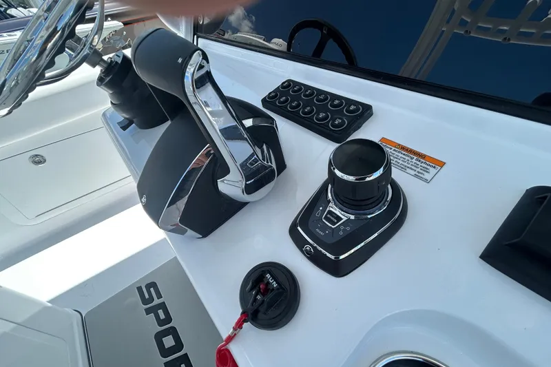Slide: The Image of 2026 Sportsman Heritage 321 Center Console boat controls and dashboard. - 9