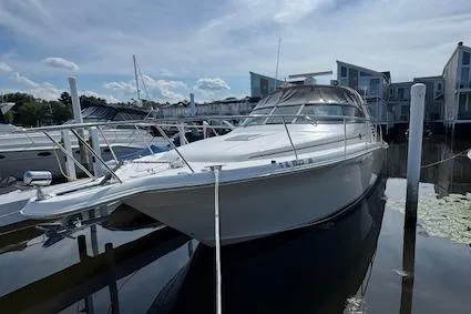 Slide: The Image of 2001 Sea Ray 340 Amberjack boat docked at marina under clear sky. - 1