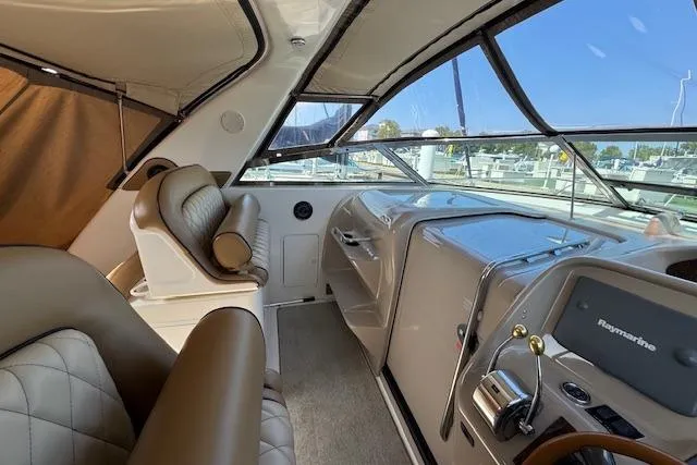 Slide: The Image of Interior of 2001 Sea Ray 340 Amberjack boat with leather seating and navigation equipment. - 10