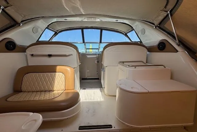 Slide: The Image of Interior of 2001 Sea Ray 340 Amberjack boat with beige seating and helm. - 11