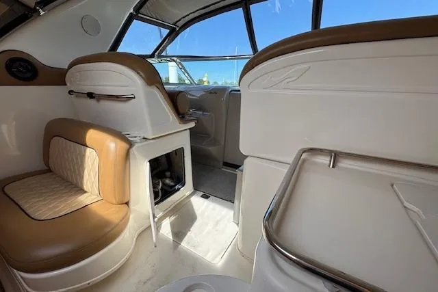 Slide: The Image of Interior of 2001 Sea Ray 340 Amberjack boat, featuring tan and white seating. - 12