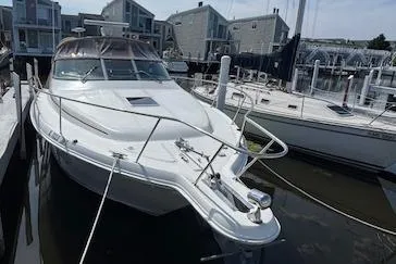 Slide: The Image of 2001 Sea Ray 340 Amberjack docked at a marina, surrounded by other boats. - 2