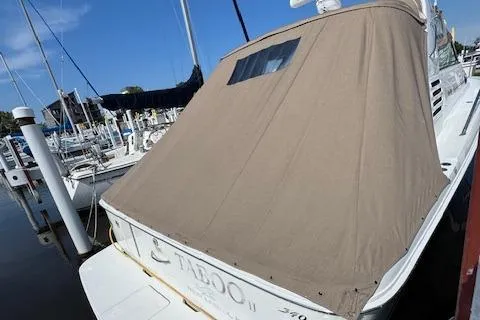Slide: The Image of 2001 Sea Ray 340 Amberjack boat with tan cover docked at marina. - 20
