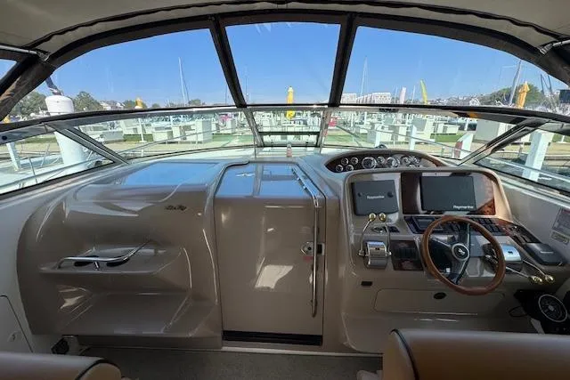 Slide: The Image of Cockpit view of 2001 Sea Ray 340 Amberjack, featuring helm controls and navigation screens. - 27