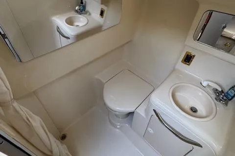 Slide: The Image of 2001 Sea Ray 340 Amberjack bathroom with sink, toilet, and mirror. - 28