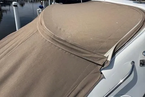 Slide: The Image of 2001 Sea Ray 340 Amberjack boat with beige canvas cover at marina. - 3