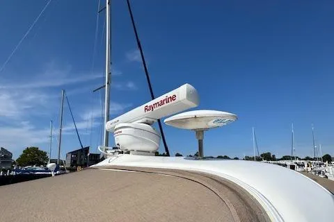 Slide: The Image of 2001 Sea Ray 340 Amberjack with Raymarine radar, docked under clear blue sky. - 4