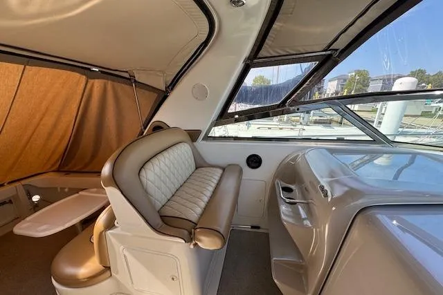 Slide: The Image of 2001 Sea Ray 340 Amberjack boat interior with beige seating and helm station. - 6