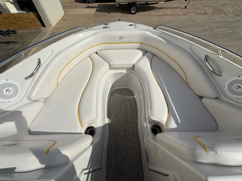 Slide: The Image of Interior of 2012 Crownline 225 SS boat with white seating and yellow accents. - 10