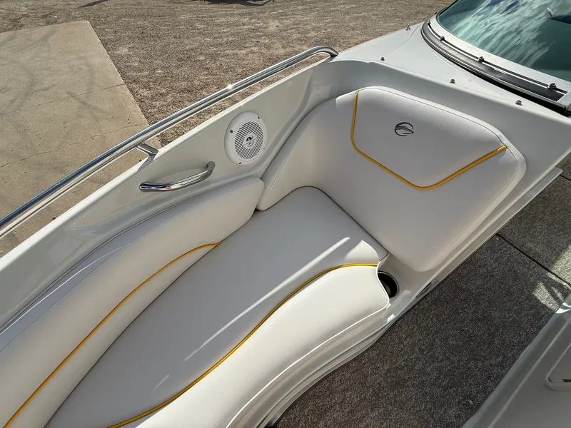 Slide: The Image of 2012 Crownline 225 SS boat interior with white seating and yellow accents. - 11