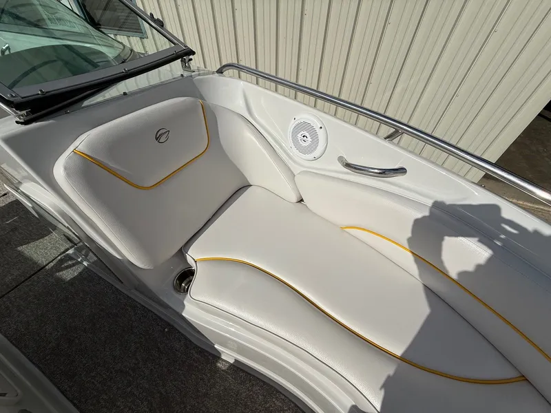 Slide: The Image of 2012 Crownline 225 SS boat interior with white seating and yellow accents. - 12