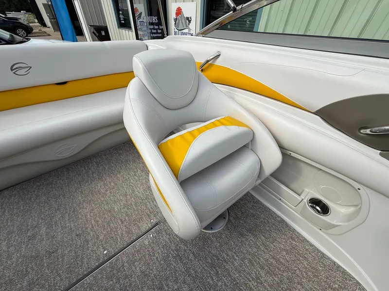 Slide: The Image of 2012 Crownline 225 SS boat interior with yellow and gray seating. - 19