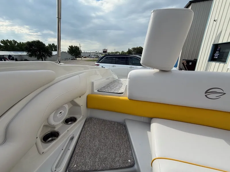 Slide: The Image of 2012 Crownline 225 SS boat interior with white and yellow seating, cup holders, and speaker. - 9