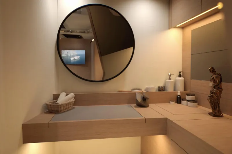 Slide: The Image of Modern bathroom interior on 2026 Dufour 54 yacht, featuring round mirror and elegant decor. - 25
