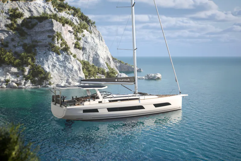 Slide: The Image of 2026 Dufour 54 yacht sailing on clear blue water. - 6