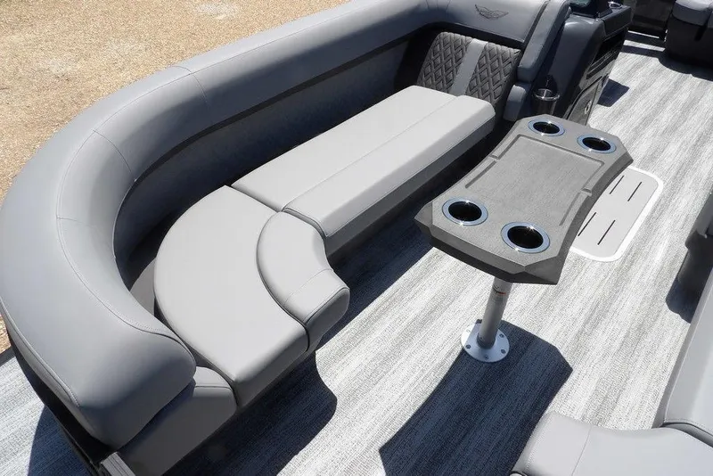 Slide: The Image of 2025 Bennington M Swingback 24 MSB boat interior with gray seating and table with cup holders. - 18