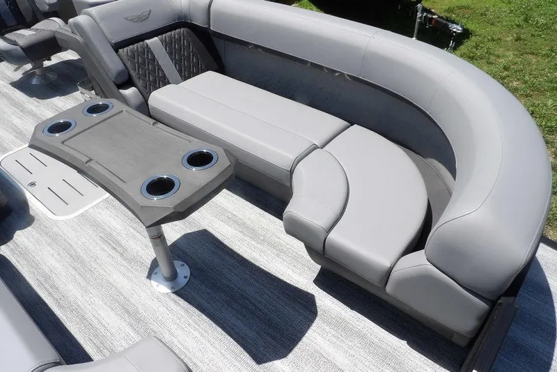 Slide: The Image of 2025 Bennington M Swingback 24 MSB boat interior with gray seating and table with cup holders. - 20