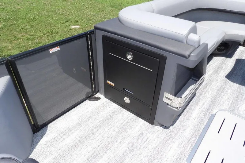 Slide: The Image of 2025 Bennington M Swingback 24 MSB interior with seating and storage compartment. - 24