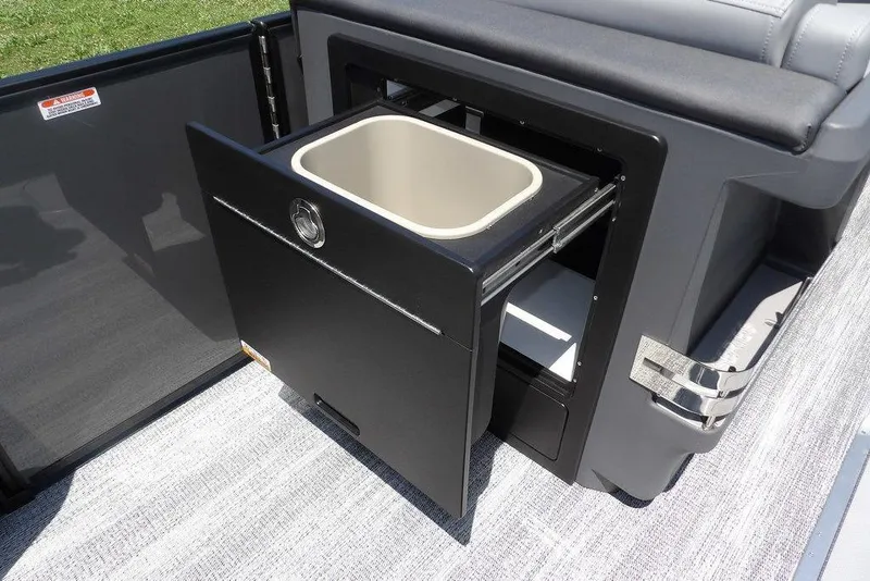 Slide: The Image of 2025 Bennington M Swingback 24 MSB with open storage compartment and pull-out bin. - 27