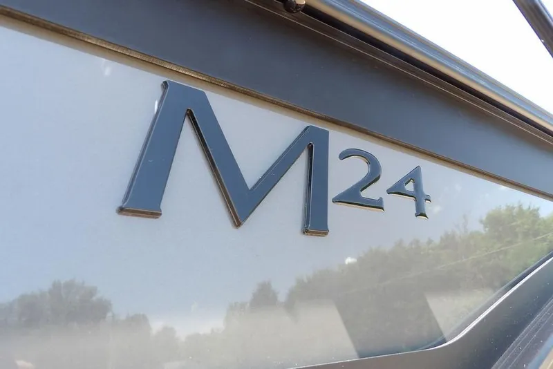 Slide: The Image of Close-up of 2025 Bennington M Swingback 24 MSB logo on boat exterior. - 3