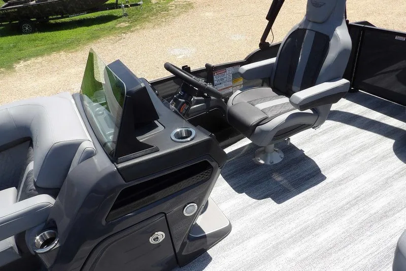 Slide: The Image of 2025 Bennington M Swingback 24 MSB boat interior with captain's chair and console. - 30