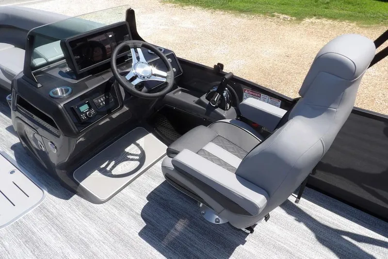 Slide: The Image of 2025 Bennington M Swingback 24 MSB boat interior with modern helm and comfortable seating. - 31