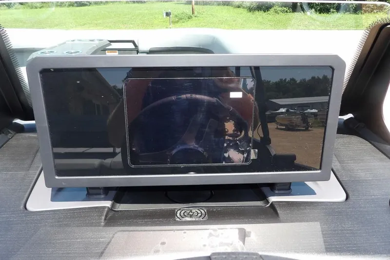 Slide: The Image of Dashboard display of 2025 Bennington M Swingback 24 MSB boat, reflecting outdoor scenery. - 34