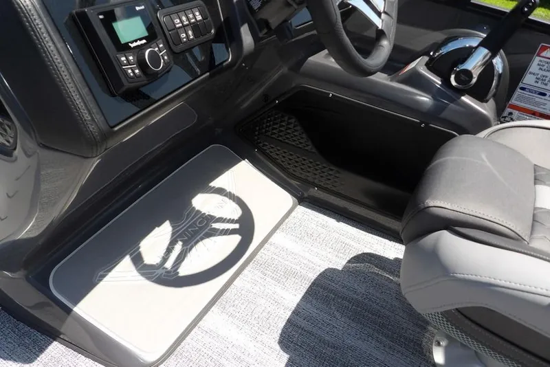 Slide: The Image of 2025 Bennington M Swingback 24 MSB boat interior with steering wheel and control panel. - 36