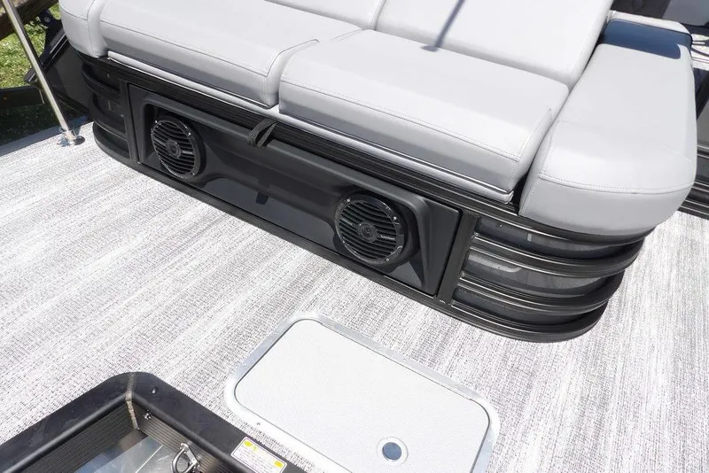 Slide: The Image of 2025 Bennington M Swingback 24 MSB boat interior with cushioned seating and built-in speakers. - 47