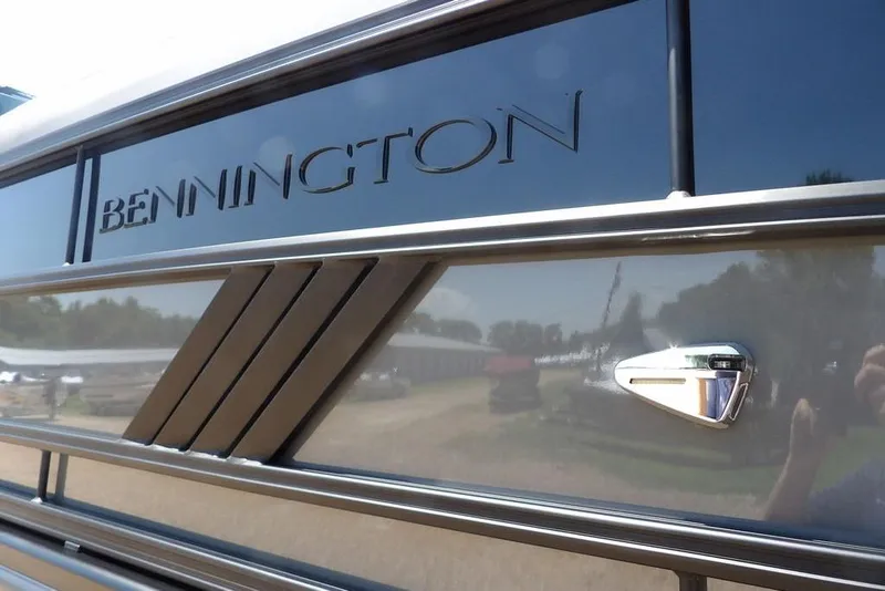 Slide: The Image of 2025 Bennington M Swingback 24 MSB boat exterior with sleek design and logo detail. - 5