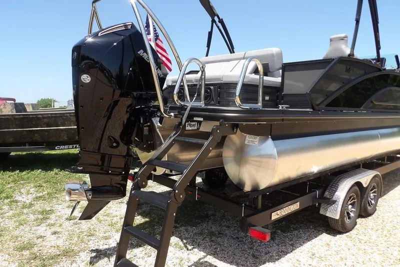 Slide: The Image of 2025 Bennington M Swingback 24 MSB pontoon boat with Mercury outboard motor and trailer. - 6