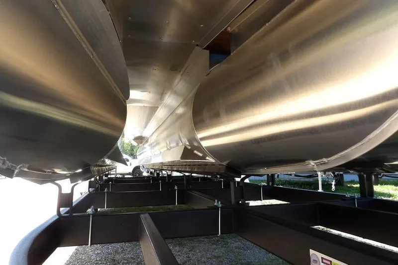 Slide: The Image of Underneath view of 2025 Bennington M Swingback 24 MSB pontoon boat on trailer. - 7