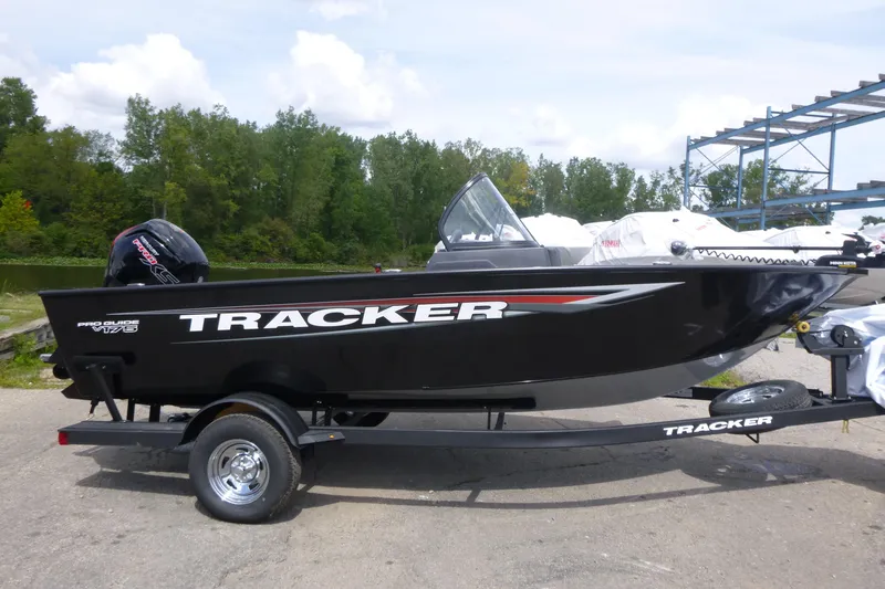 The Image of 2026 Tracker Pro Guide V-175 Combo boat on trailer, parked outdoors. - 1