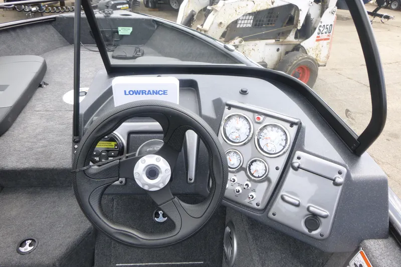 Slide: The Image of 2026 Tracker Pro Guide V-175 Combo boat dashboard with steering wheel and gauges. - 11