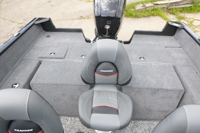 Slide: The Image of 2026 Tracker Pro Guide V-175 Combo boat interior with gray seating and carpeted deck. - 12