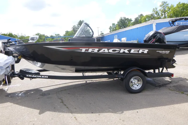 Slide: The Image of 2026 Tracker Pro Guide V-175 Combo boat on trailer, parked outdoors. - 4