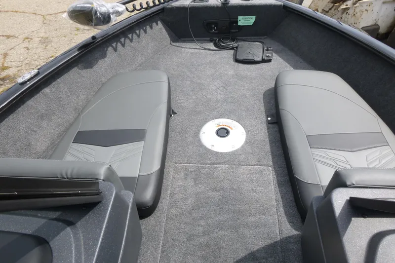 Slide: The Image of 2026 Tracker Pro Guide V-175 Combo boat interior with gray seating and carpeted floor. - 7