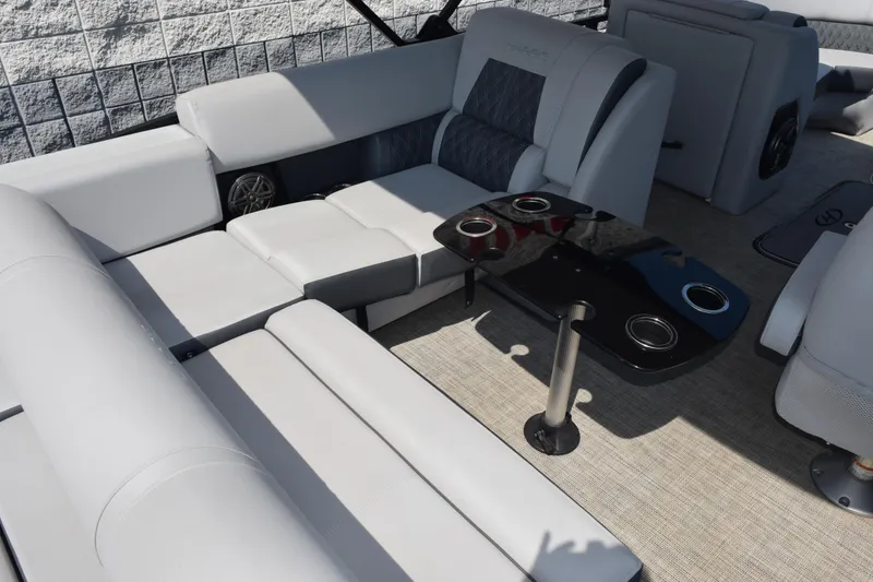 Slide: The Image of Luxurious seating area on 2020 Harris Solstice 230 boat with sleek table and cup holders. - 10
