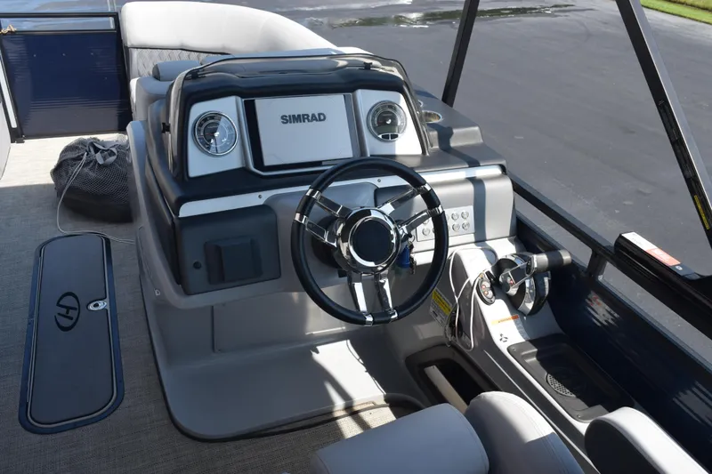 Slide: The Image of Helm of 2020 Harris Solstice 230 boat with Simrad display and steering wheel. - 11