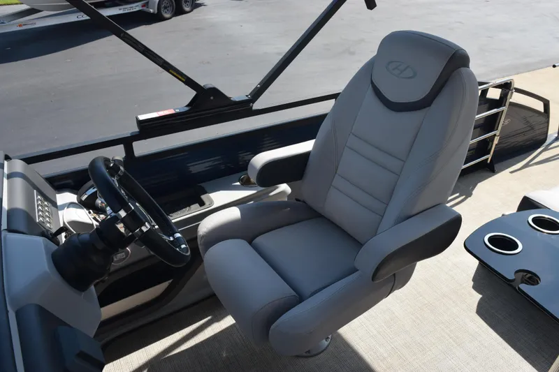 Slide: The Image of Captain's chair and steering wheel of 2020 Harris Solstice 230 boat, featuring modern design. - 12