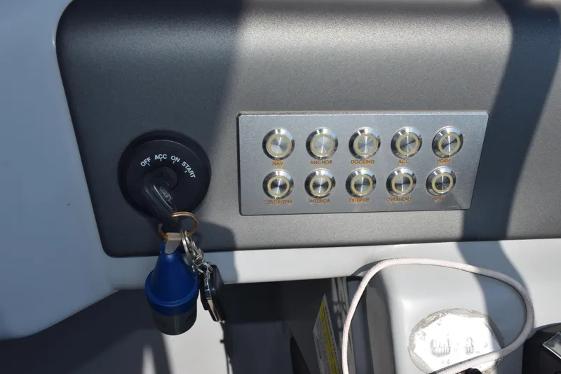 Slide: The Image of Control panel of a 2020 Harris Solstice 230 boat with ignition and switches. - 15