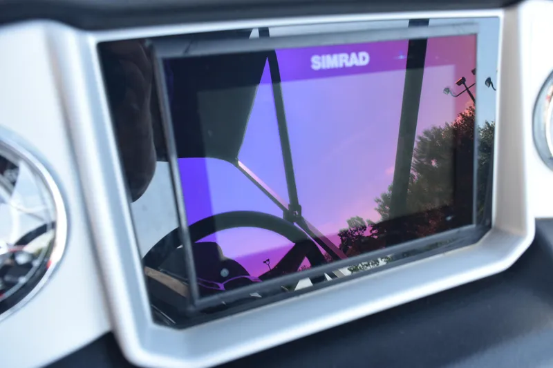 Slide: The Image of Simrad display on 2020 Harris Solstice 230 boat dashboard, reflecting vibrant sky. - 16
