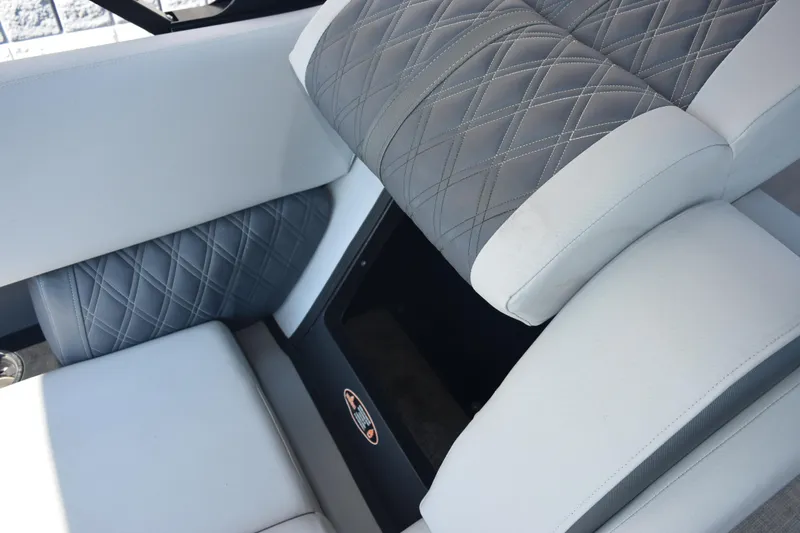 Slide: The Image of 2020 Harris Solstice 230 boat interior with gray and white quilted seating. - 23