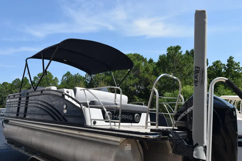 Slide: The Image of 2020 Harris Solstice 230 pontoon boat with canopy, docked outdoors. - 7